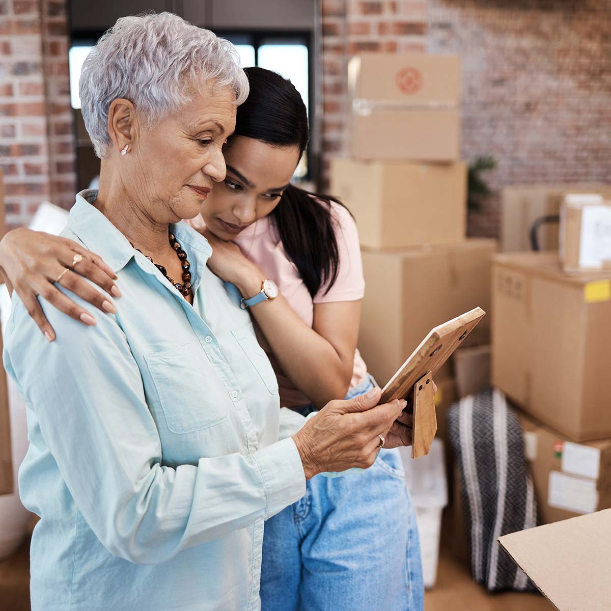 image of senior woman looking at a picture during packing for move.